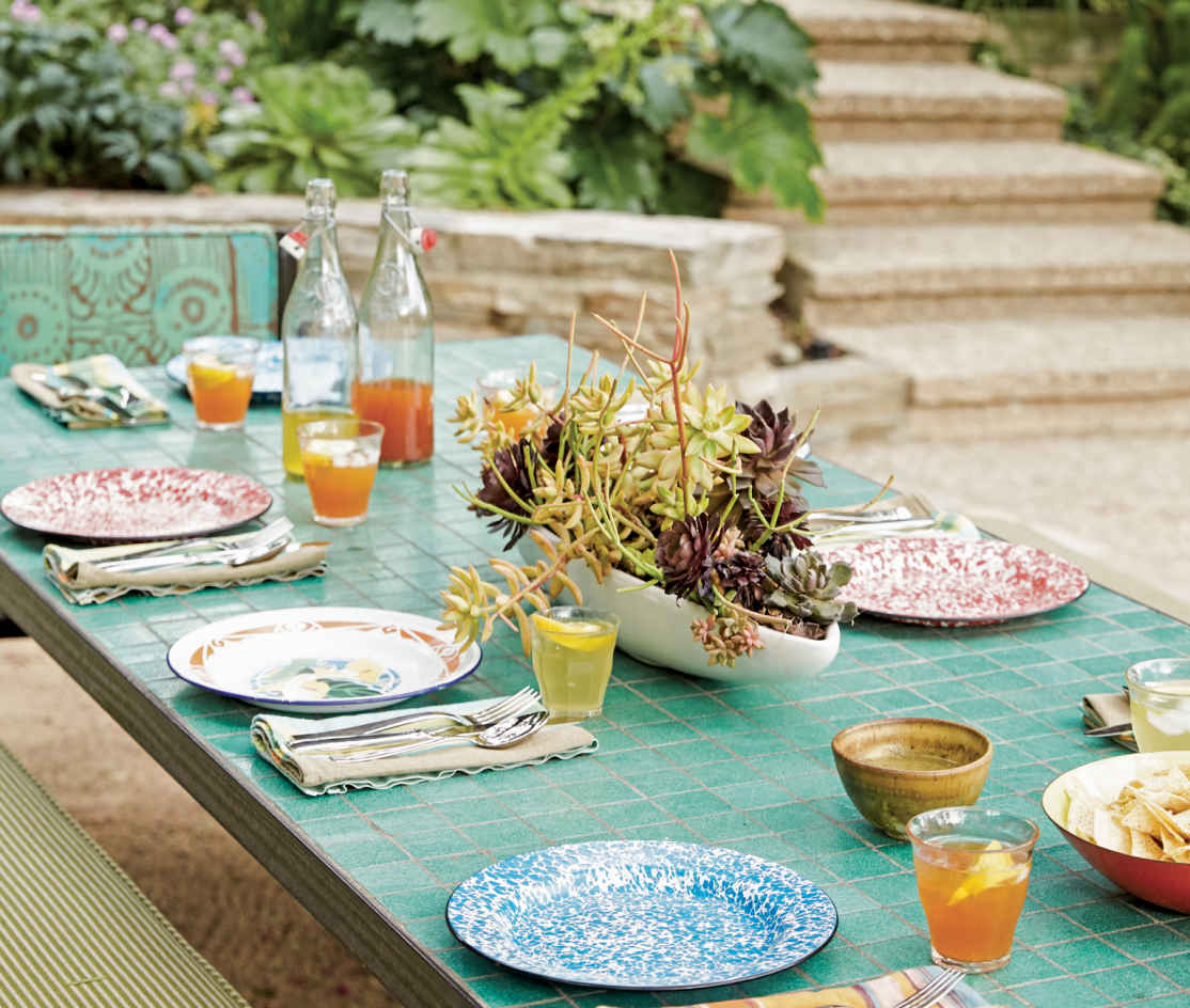 MOSAIC MEALS. Great outdoors and easy to clean, this glass-tile-topped table is the homeowners’ own design and comes in fifteen different shades, providing a great opportunity to add color where most folks choose a neutral wood.