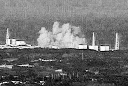 Captured by an NHK camera positioned about twenty miles away, the explosion inside Unit 1 at 3:36 p.m. on March 12 destroys the roof of the reactor building and blows out a panel in the adjacent Unit 2 reactor building. NHK