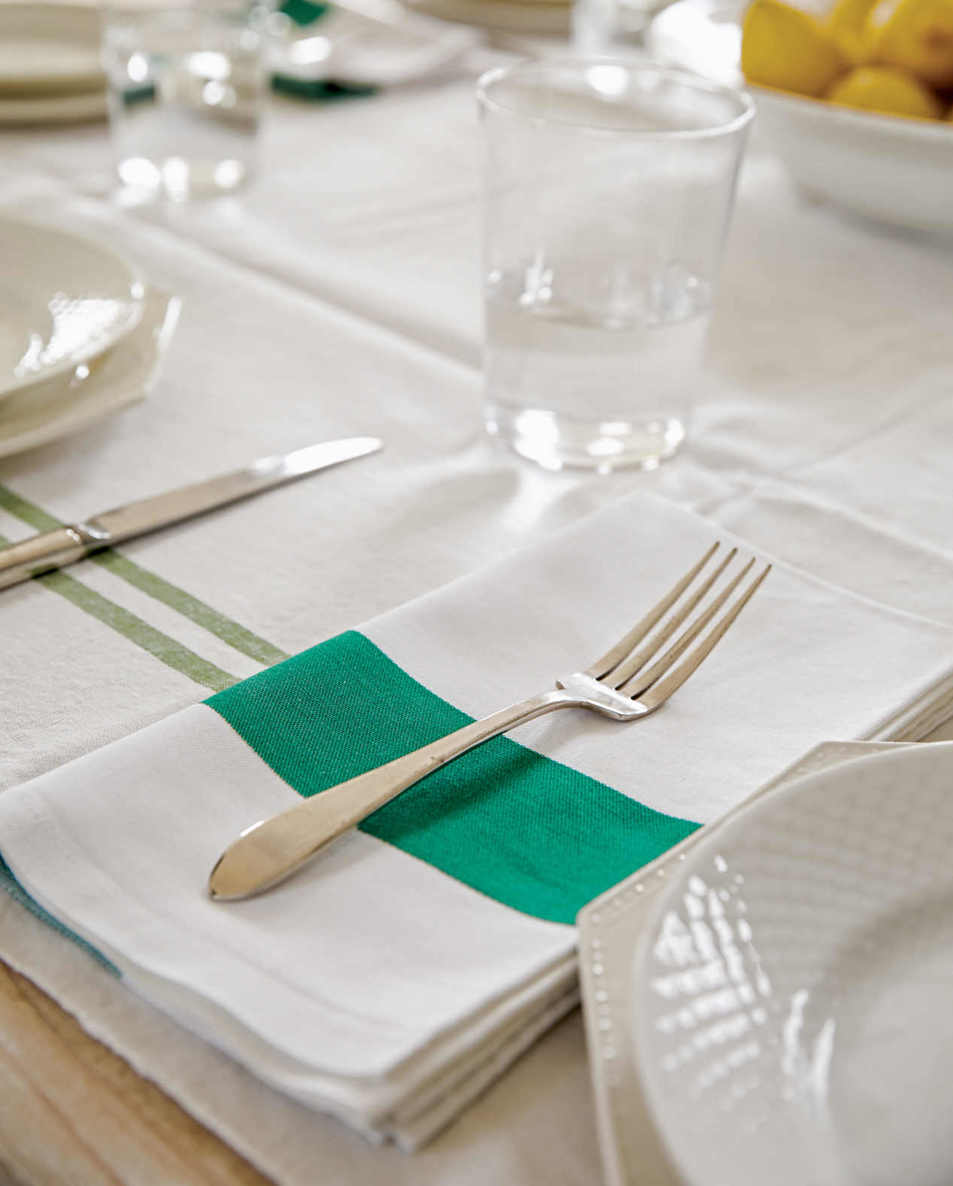 SPRING GREEN. Vintage Frette napkins with thick green stripes add just the right pop of color to this all-white tablescape.
