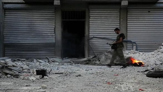 File:Free Syrian Army soldier walking among rubble in Aleppo